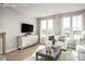 Cozy living room featuring large windows, a TV, a sofa, and a modern console at 1474 Samuel St, Charlotte, NC 28206