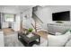 Open-concept living room with stairs, sleek decor, and seamless flow to the kitchen at 1474 Samuel St, Charlotte, NC 28206