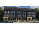 Attractive townhome exteriors feature a mix of stone and dark siding with dark trim and coordinated entryways at 1478 Samuel St, Charlotte, NC 28206