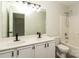 Bright bathroom featuring double sinks with black faucets and a shower-tub combination at 1628 Sandpiper Dr, Rock Hill, SC 29732