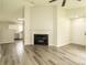 Open-concept living room with fireplace and luxury vinyl plank flooring at 1628 Sandpiper Dr, Rock Hill, SC 29732