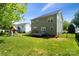Well-maintained backyard with a lush lawn, deck, play set, and partial fence at 1677 Shetland Ln, Rock Hill, SC 29730