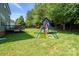 Backyard with a swing set, trees, and a privacy fence at 1677 Shetland Ln, Rock Hill, SC 29730