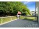Backyard deck overlooking the backyard with a swing set and mature trees at 1677 Shetland Ln, Rock Hill, SC 29730