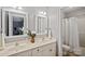 Bright bathroom with dual sinks, modern fixtures, framed mirrors, and a shower tub combination at 1677 Shetland Ln, Rock Hill, SC 29730