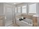 Bathroom featuring a soaking tub, and shower with glass doors. Bathtub has modern faucet fixtures at 1677 Shetland Ln, Rock Hill, SC 29730