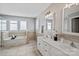 Bright bathroom with soaking tub, double vanity, tile flooring, and lots of natural light at 1677 Shetland Ln, Rock Hill, SC 29730