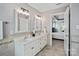 Bright bathroom boasts double vanity, white cabinetry, tile flooring, and a doorway to the bedroom at 1677 Shetland Ln, Rock Hill, SC 29730