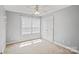 Neutral bedroom with carpet, ceiling fan, closet, and large window offering plenty of natural light at 1677 Shetland Ln, Rock Hill, SC 29730