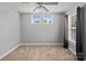 Well-lit bedroom featuring neutral walls, plush carpeting, ceiling fan, and ample natural light from the windows at 1677 Shetland Ln, Rock Hill, SC 29730