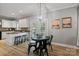 Cozy dining area with a modern chandelier, dark metal furniture, and kitchen in the background at 1677 Shetland Ln, Rock Hill, SC 29730