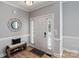 Bright foyer featuring wood flooring, a decorative mirror, and ample natural light at 1677 Shetland Ln, Rock Hill, SC 29730