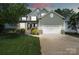 Charming two-story home featuring stone accents, a well-manicured lawn, and a two-car garage at 1677 Shetland Ln, Rock Hill, SC 29730
