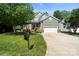 Charming two-story home featuring stone accents, a well-manicured lawn, and a two-car garage at 1677 Shetland Ln, Rock Hill, SC 29730