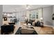 Cozy living room with a large window, plush seating, and an open floor plan to the kitchen and dining area at 1677 Shetland Ln, Rock Hill, SC 29730