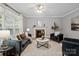 Bright living room with stylish furniture, a cozy fireplace, and a view of the outdoors at 1677 Shetland Ln, Rock Hill, SC 29730
