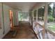 Relaxing back porch with screen offering fresh air and tranquil views of the backyard at 180 Tower Rd, Troy, NC 27371