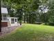 A home featuring a screened-in porch and a big yard, providing serene outdoor living and entertaining at 180 Tower Rd, Troy, NC 27371