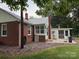 Brick home featuring a back porch and a spacious yard, perfect for outdoor relaxation and entertaining at 180 Tower Rd, Troy, NC 27371