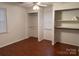 Bright bedroom featuring wood flooring, built in shelving, and a ceiling fan at 180 Tower Rd, Troy, NC 27371