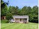 Charming single-story home with well-maintained lawn and inviting front porch at 201 N Ferry St, New London, NC 28127