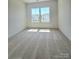 Bright, carpeted bedroom with a double window at 2137 Barrowcliffe Dr # 49, Concord, NC 28027