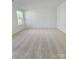 Neutral bedroom with a large window for natural light and plush carpet at 2137 Barrowcliffe Dr # 49, Concord, NC 28027