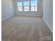 Bedroom with neutral carpeting and large windows offering neighborhood views at 2137 Barrowcliffe Dr # 49, Concord, NC 28027