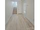 Hallway features hard surface flooring, neutral paint and provides access to various rooms in the home at 2137 Barrowcliffe Dr # 49, Concord, NC 28027