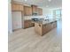 Bright kitchen features a large island with granite countertops and stainless steel appliances at 2137 Barrowcliffe Dr # 49, Concord, NC 28027