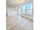 Bright living area with hardwood floors, large windows, and access to a balcony at 2137 Barrowcliffe Dr # 49, Concord, NC 28027