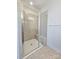 Walk-in shower with gray tile surround, bench, and glass door at 2137 Barrowcliffe Dr # 49, Concord, NC 28027