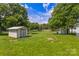 Spacious backyard with storage shed and lush lawn, perfect for outdoor activities and relaxation at 2488 Catawba Church Rd, Rock Hill, SC 29730
