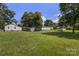 Expansive backyard featuring a well-maintained lawn, a storage shed, and mature trees at 2488 Catawba Church Rd, Rock Hill, SC 29730