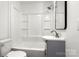 This bathroom boasts a shower-tub combo, white tile surround, gray vanity with mirror, and a toilet at 2488 Catawba Church Rd, Rock Hill, SC 29730