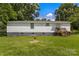 A single-story home with white siding, a well-maintained lawn, and a welcoming back porch at 2488 Catawba Church Rd, Rock Hill, SC 29730