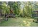 A spacious yard with a treehouse is nestled in the shade of the surrounding mature trees at 2615 Highway 557 None, Clover, SC 29710