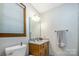 Simple bathroom featuring a single-sink vanity, a framed mirror, and a window for natural light at 2615 Highway 557 None, Clover, SC 29710