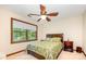 Cozy bedroom featuring a ceiling fan, and a window overlooking the wooded landscape at 2615 Highway 557 None, Clover, SC 29710