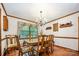 Bright dining room showcases hardwood floors, chandelier, and a wood table with seating for six, plus floral valance window treatment at 2615 Highway 557 None, Clover, SC 29710