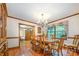 Traditional dining room boasts hardwood floors, chandelier, wood table with seating for eight, plus floral valance window treatment at 2615 Highway 557 None, Clover, SC 29710
