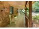 Spacious covered front porch with seating area and charming rustic details at 2615 Highway 557 None, Clover, SC 29710