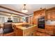 Kitchen with a butcher block island with cooktop, wood cabinets, and double ovens, opens to the living room at 2615 Highway 557 None, Clover, SC 29710