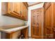 Utility room with white counters, wooden cabinets, and a storage closet; washer and dryer hookups not visible at 2615 Highway 557 None, Clover, SC 29710