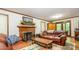 Cozy living room with a brick fireplace, leather couches, and a wooden coffee table on an ornate rug at 2615 Highway 557 None, Clover, SC 29710