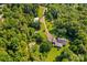 Aerial view of a home on sprawling lot, complete with outbuildings and lush landscaping at 265 River Run Rd, Statesville, NC 28625