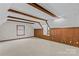 Spacious attic area featuring beamed ceiling, wood paneled walls, and neutral carpeting at 265 River Run Rd, Statesville, NC 28625