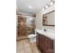 Bathroom featuring tiled shower, dark vanity, and neutral tile floor at 265 River Run Rd, Statesville, NC 28625