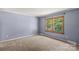 Bedroom with blue walls and large picture window providing an abundance of natural light at 265 River Run Rd, Statesville, NC 28625