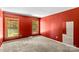This bedroom has red walls, two windows, and new neutral carpet at 265 River Run Rd, Statesville, NC 28625